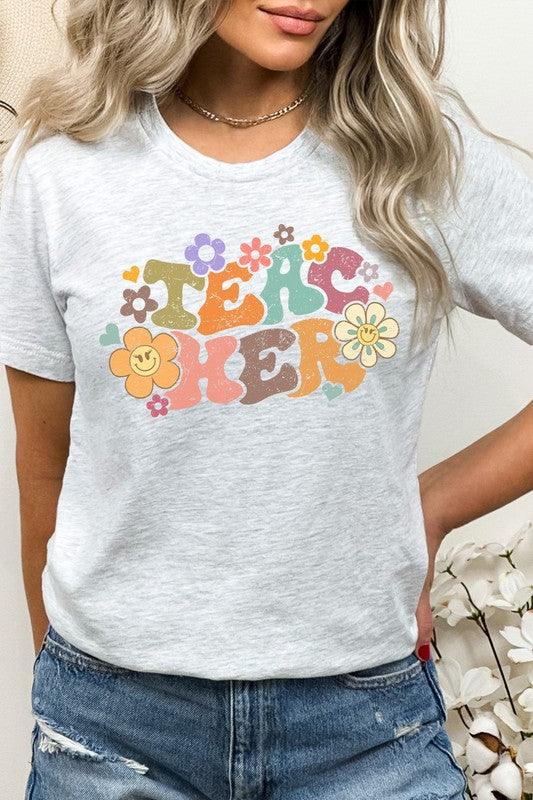 Pastel 'Teacher" Floral Lash Smiley Graphic Tee - Klazzi Fashion Boutique